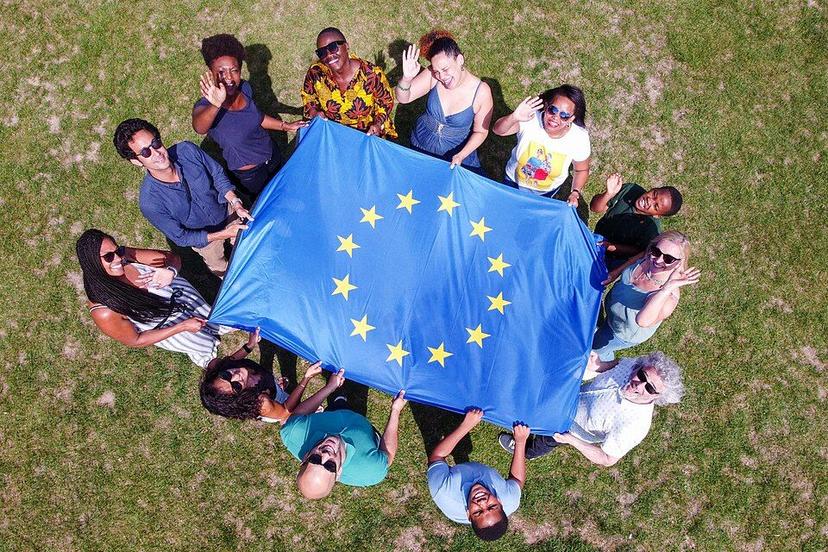 Group_of_multicultural_people_holding_a_European_flag_(P044728-947695).jpg